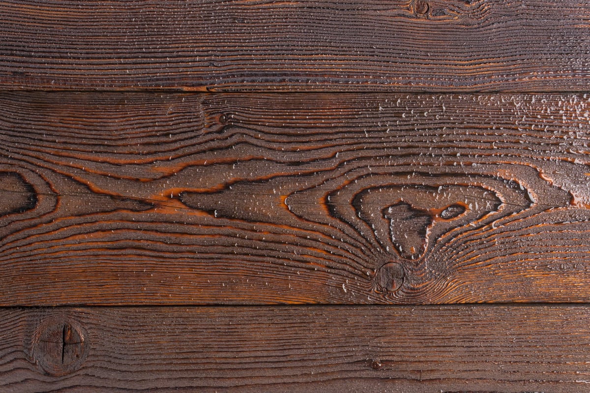 Dark natural stone surface with textured grain