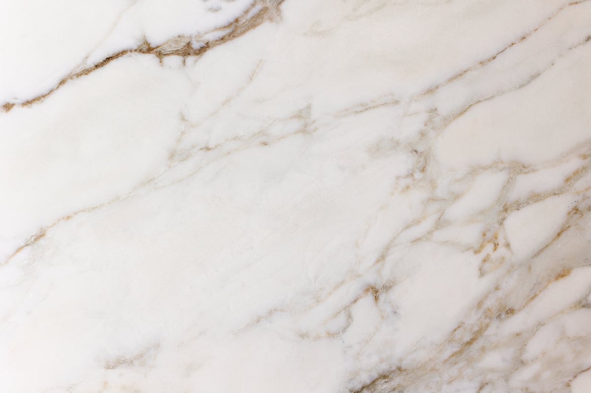 Polished slab of white marble with elegant natural veining